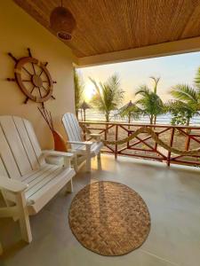 a room with two chairs and a clock on the wall at Laguna Beach Ecohotel in Tolú