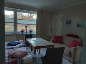 a living room with a couch and a table at Labahn in Lohme
