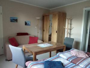 a living room with a table and a couch at Labahn in Lohme