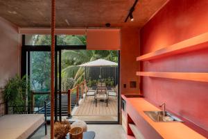 an external view of a house with a kitchen and a deck at The Sandhaus - Boutique Design Villa with 8 Suites in Jacó