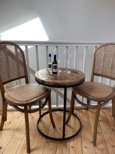 a table and two chairs with wine bottles and glasses at The Old Hayloft Beverley Town Centre in Beverley