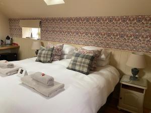 a bedroom with two white beds with towels on them at The Old Hayloft Beverley Town Centre in Beverley