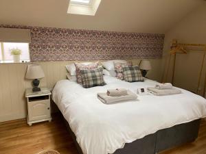 a bedroom with a large bed with towels on it at The Old Hayloft Beverley Town Centre in Beverley