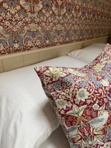 a bed with a pillow on top of it at The Old Hayloft Beverley Town Centre in Beverley