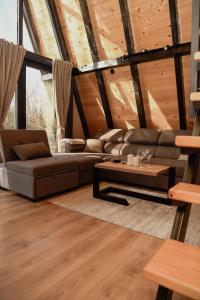a living room with a couch and a coffee table at A frame CHILL House in Brasina