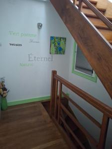 a staircase in a house with a sign on the wall at Chambre dans village tranquille in Saint-Laurent-de-la-Plaine