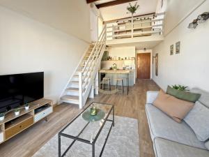 a living room with a couch and a tv at Duplex T2 - Madonna di a Sarra in Calvi
