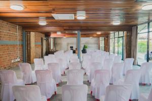 a row of white chairs in a room at Wisdom Park Caravan Camp Pattaya in Ban Khao Mai Kaeo +115 photos