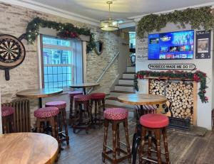 a bar with tables and stools in a restaurant at Crown & Crossed Swords in Shotley Bridge