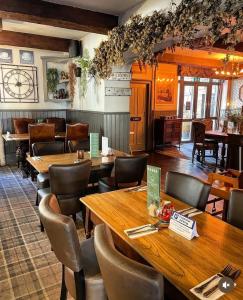 a dining room with wooden tables and chairs at Crown & Crossed Swords in Shotley Bridge