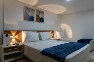 a hotel room with a bed with a blue blanket at Tambaú Beira-Mar in João Pessoa +44 photos
