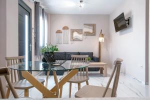 a dining room with a glass table and chairs at GreKa apartments in Kalives Poligirou +30 photos