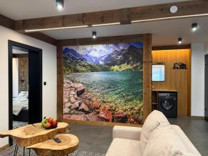 a room with a wall mural of a lake and mountains at GreenHill Bachleda in Zakopane