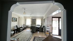 a living room with a table and chairs at Bozcaada Bag Evi in Bozcaada