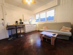 a living room with a couch and a table at Le 5BG Signature in Dunkerque