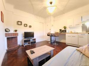 a living room with a couch and a table at Le 5BG Signature in Dunkerque