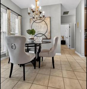 a dining room with a table and chairs and a chandelier at Master Suite with Private Jacuzzi Tub in McDonough +22 photos