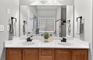 a bathroom with two sinks and a large mirror at Master Suite with Private Jacuzzi Tub in McDonough