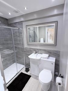 a bathroom with a shower and a toilet and a sink at Crown & Crossed Swords in Shotley Bridge +24 photos
