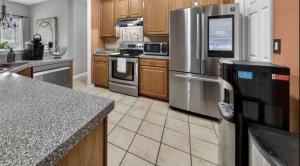 a kitchen with stainless steel appliances and wooden cabinets at Master Suite with Private Jacuzzi Tub in McDonough