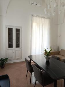 a living room with a table and a couch at Dimora Novecento Lecce in Lecce