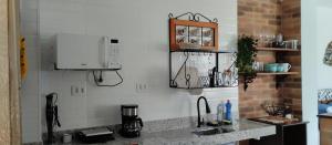 a kitchen with a sink and a counter top at Central Apartment 03 in Ouro Preto