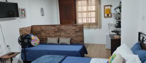 a living room with a couch and a brick wall at Central Apartment 03 in Ouro Preto