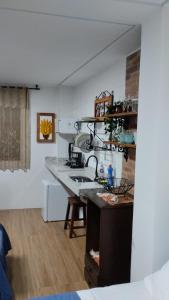 a kitchen with a sink and a counter top at Central Apartment 03 in Ouro Preto