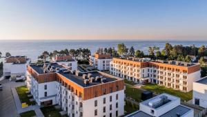 an aerial view of buildings in front of the ocean at Apartament Boho Let's Sea Gąski in Gąski