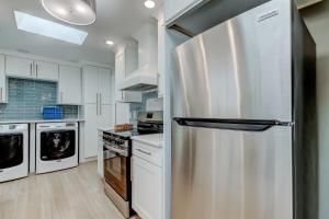 a kitchen with a stainless steel refrigerator at Indian Rocks Beach West Side Bungalow in Clearwater Beach