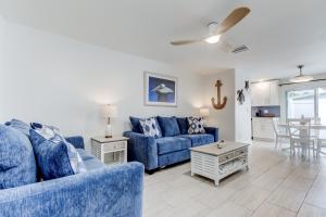 a living room with two blue couches and a table at Indian Rocks Beach West Side Bungalow in Clearwater Beach