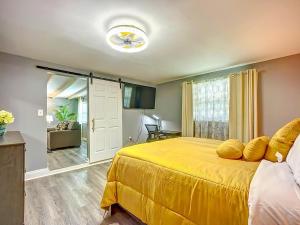 a bedroom with a large yellow bed with yellow pillows at Private Guest House 10 Min to Airport & Downtown in Jacksonville