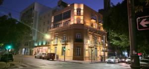 a tall building on a city street at night at Hotel del Sol in La Plata