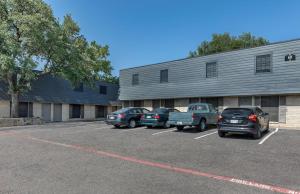 a group of cars parked in a parking lot in front of a building at Modern 2BR townhome with full kitchen & dining in Arlington