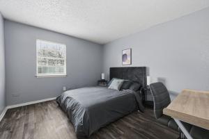 a bedroom with a bed and a table and a window at Modern 2BR townhome with full kitchen & dining in Arlington +12 photos