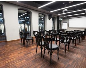 a room with a bunch of chairs and a projection screen at Best Western Hotel Mariacki Katowice in Katowice