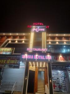 a hotel with neon signs on the front of it at Hotel kanha Royal Inn in Jodhpur