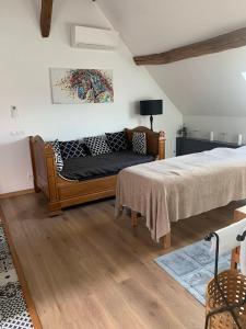 a bedroom with a bed and a couch at Le relais de poste Valero in Serazereux