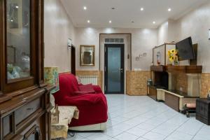 a living room with a red couch and a tv at Casa Vacanze Chiara in Terni