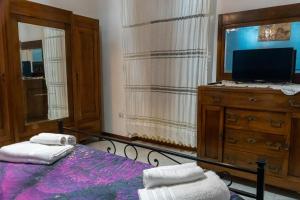 a bedroom with a bed and a dresser and a tv at Casa Vacanze Chiara in Terni +4 photos