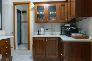 a kitchen with wooden cabinets and a counter top at Casa Vacanze Chiara in Terni