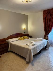 a bedroom with a bed with two towels on it at Villa Altieri in Albano Laziale