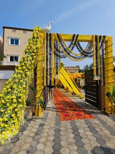 a stage with a bunch of yellow and red flowers at MAHAMAYA CONVENTION and HOTEL in Mālatīpātpur