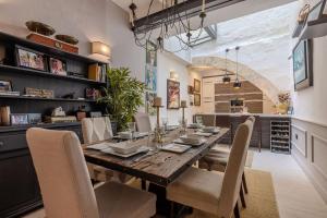 a dining room with a wooden table and chairs at Elegant Maltese Townhouse in Attard