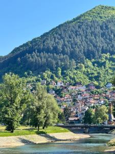 a small town on a hill next to a river at Apartment Donna in Visoko