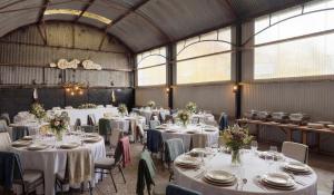 a room filled with tables and chairs with white table settings at Fitz of Inch - Entire Venue Rental in Stradbally