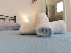 a stuffed animal is laying on a bed at Meltemi Chora Amorgos Panoramic View in Amorgos