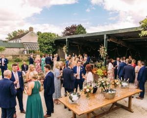 a group of people standing around a table at a wedding at Fitz of Inch - Entire Venue Rental in Stradbally