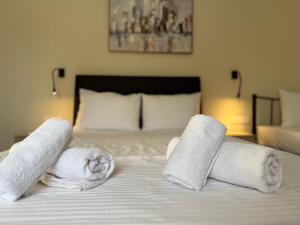 a bed with towels on top of it at Alexandra Apartment in Agíasma