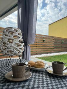 a table with two cups of coffee and pastries on it at Alexandra Apartment in Agíasma